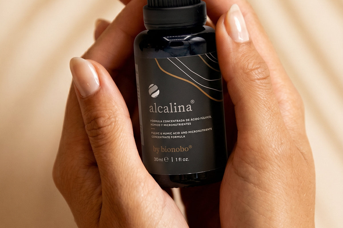 Two hands cradling a bottle of alcalina fulvic biominerals